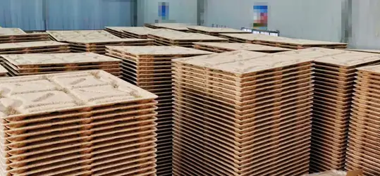 Stacked presswood pallets in warehouse_副本.webp