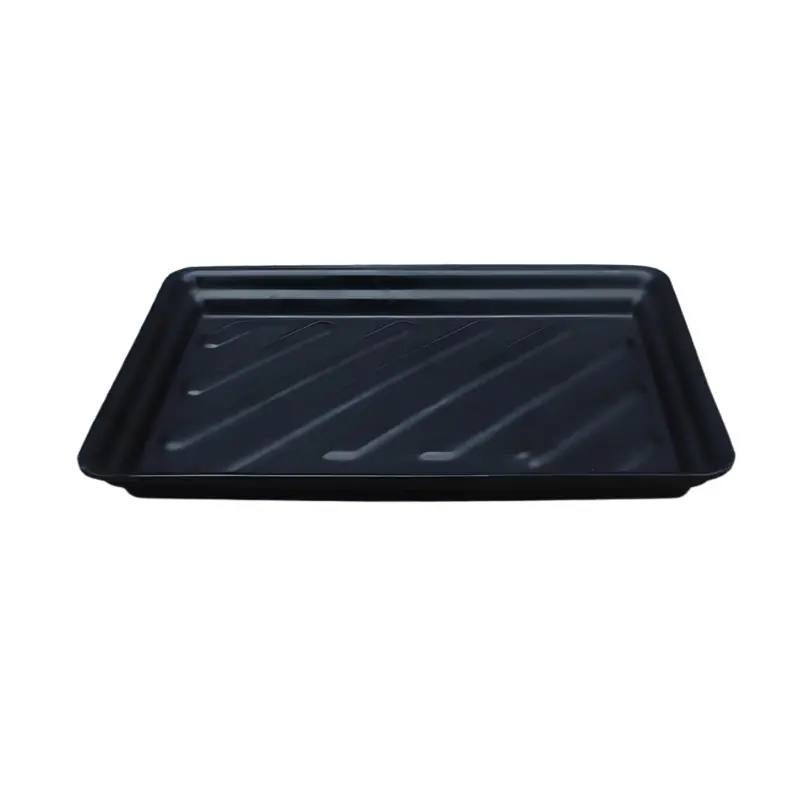 Spill tray in factory setting containing oils.webp
